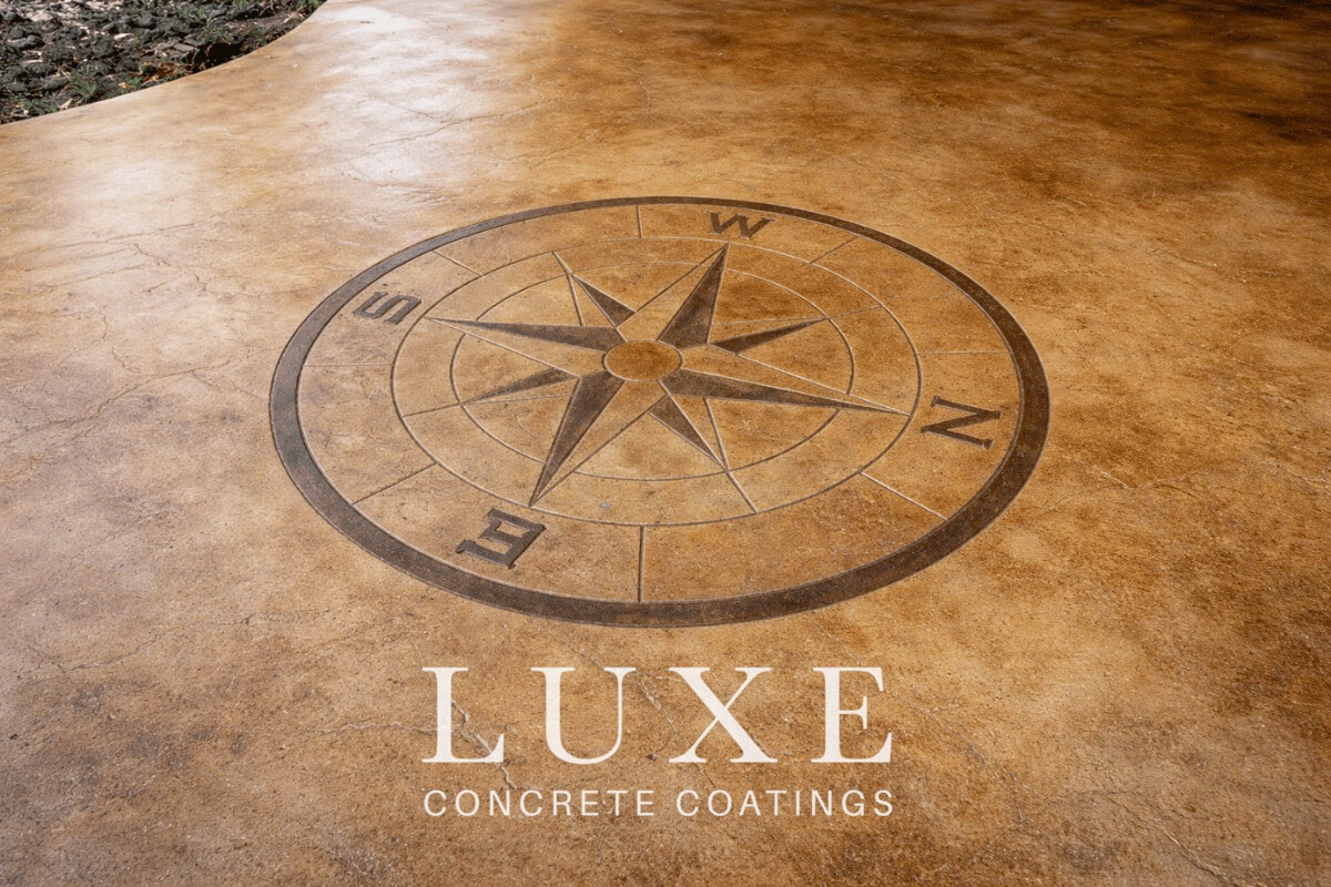 stained concrete patio with compass stamp design by Luxe Concrete Coatings